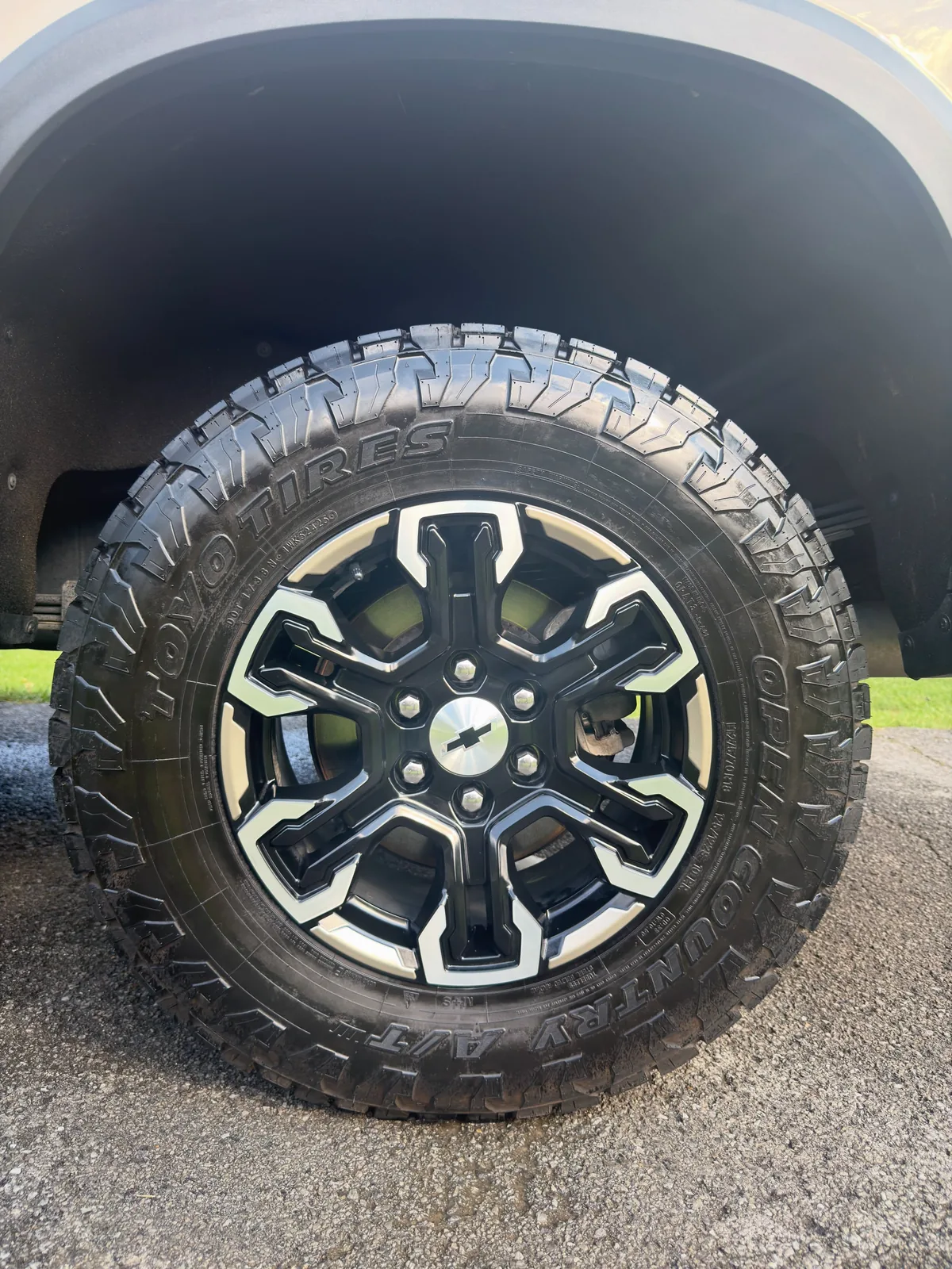 Machined black Chevrolet wheel and Toyo tire cleaned and dressed