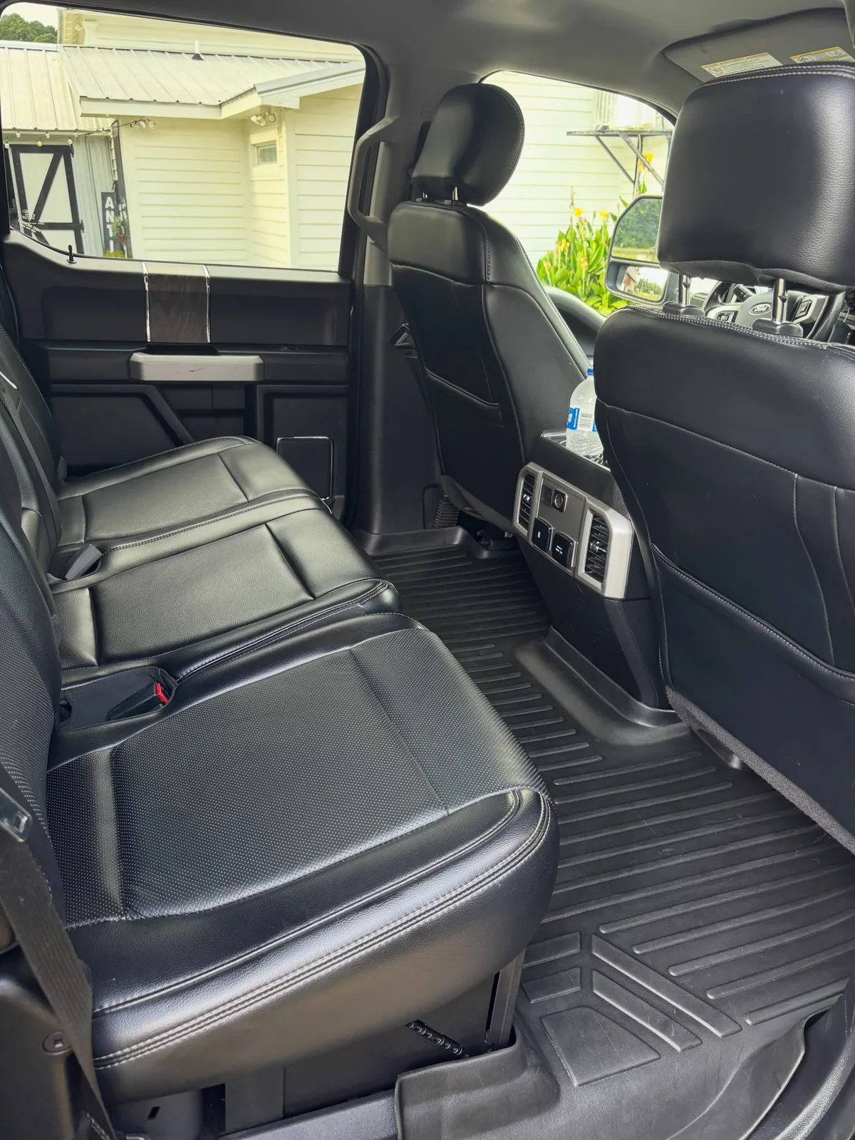 Ford F-250 rear cabin with cleaned black leather seats and rubber floor liners