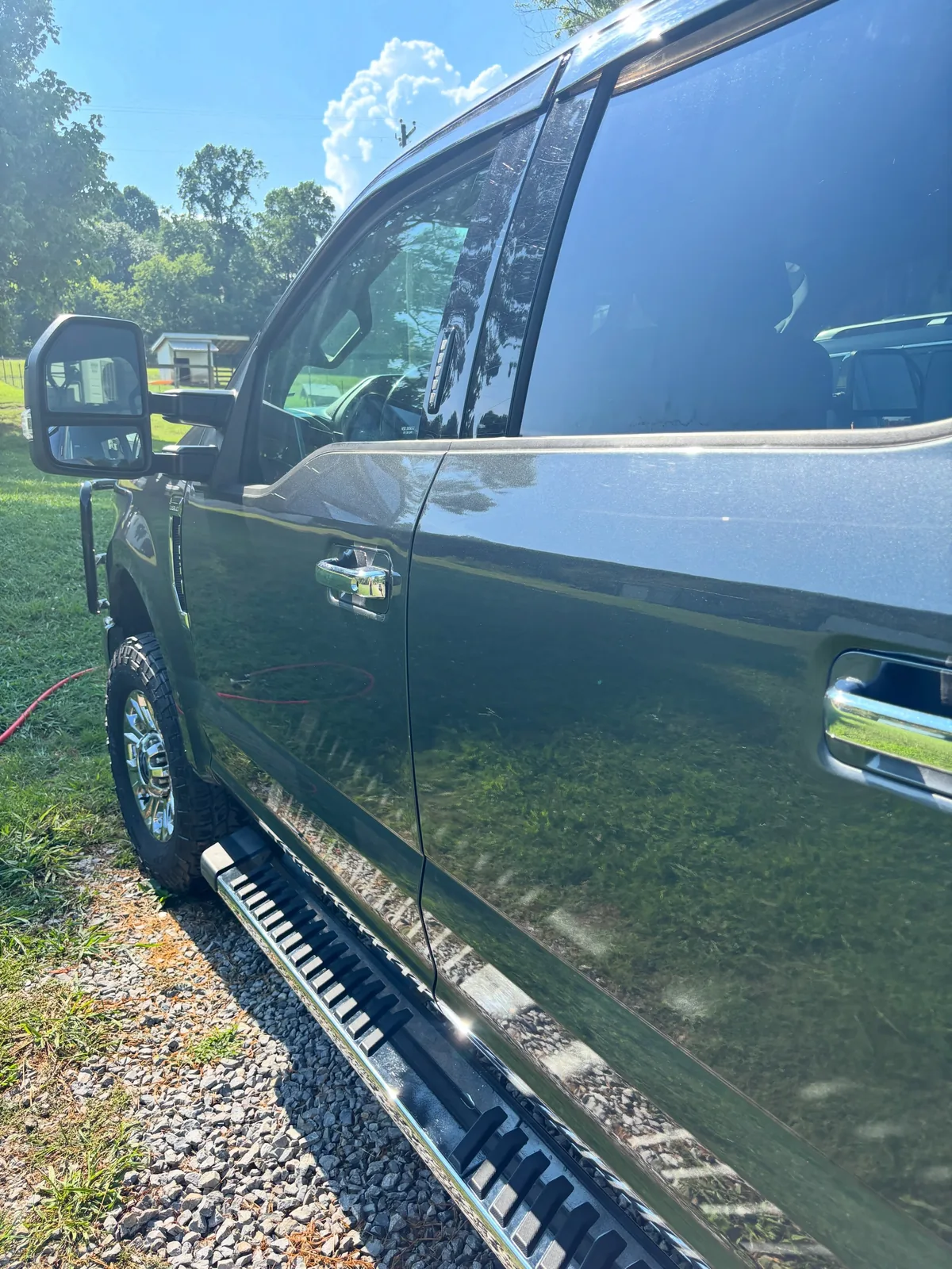 Grey Ford Super Duty door and cab panel reflecting clearly after polishing