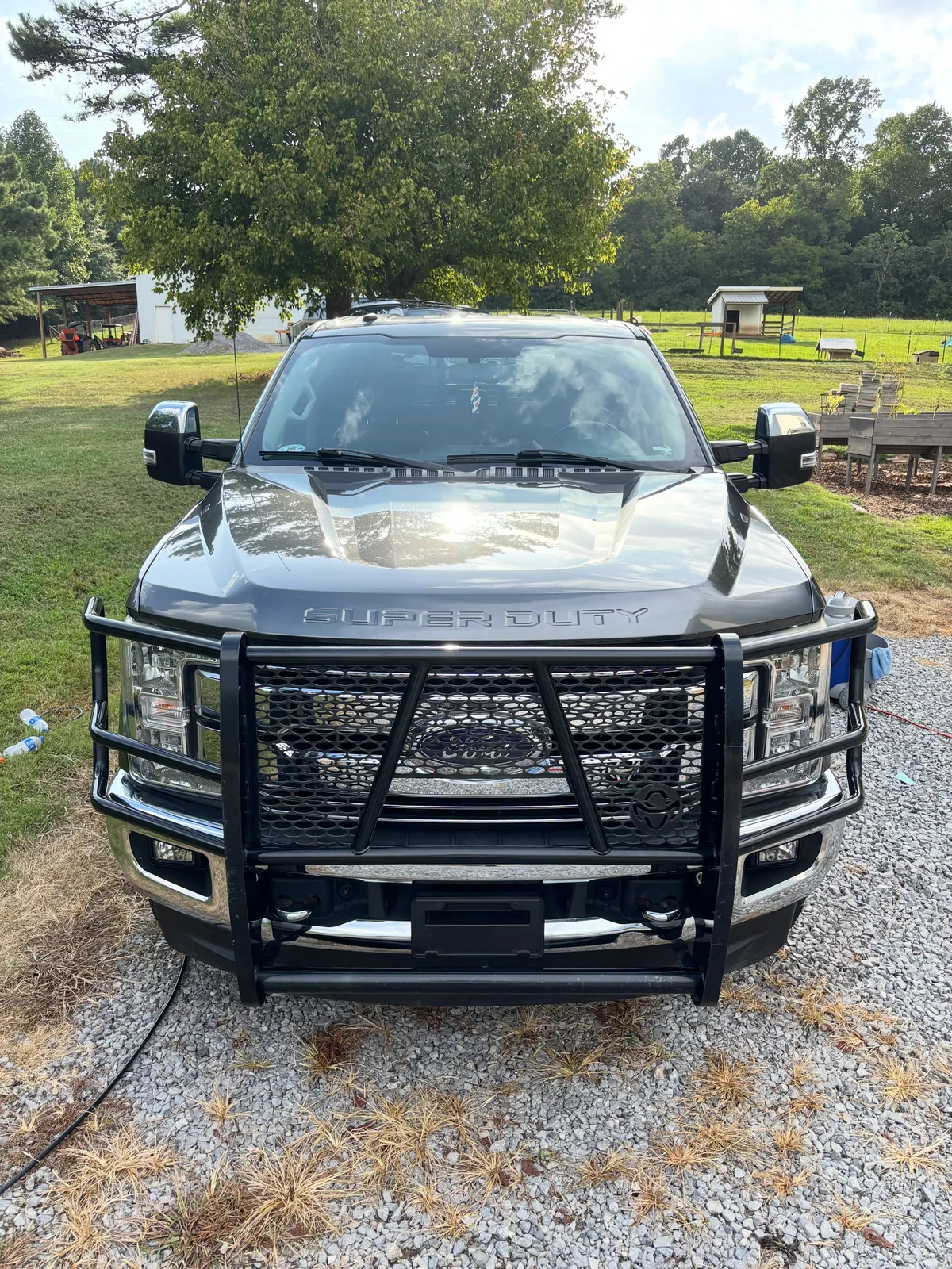 Ford Super Duty front end with a black brush guard, cleaned and detailed